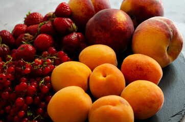 fresh fruits and berries close-up, currants peaches, strawberries