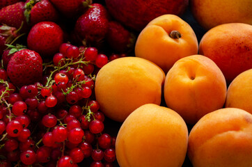 Naklejka na ściany i meble fresh fruits and berries close-up, currants peaches, strawberries
