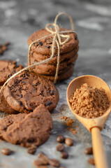 cookies with pieces of chocolate tied with a thread lie on a table sprinkled with cocoa powder