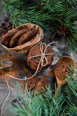 cookies with pieces of chocolate tied with a string on the background of fir branches. Christmas cookies