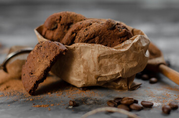 cookies with pieces of chocolate tied with a thread lie on a table sprinkled with cocoa powder