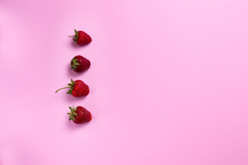Ripe strawberries on a colored background. Copy space. Top view. Horizontal orientation.