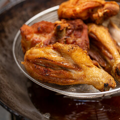 Fried chicken in hot oil and boiling in pan