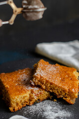 cake on the table sprinkled with powdered sugar