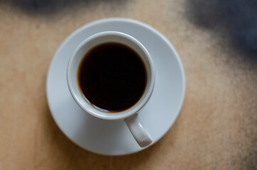 white cup of coffee on the table painted with black paint