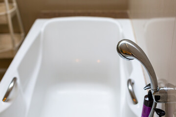 Faucets attached to the bathtub in the hotel bathroom