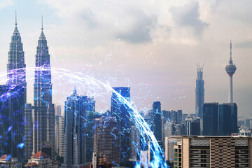 Fototapeta premium Hologram ikony abstrakcyjna technologii nad widokiem na panoramę miasta Kuala Lumpur, Malezja, Azja. Pojęcie sieci i połączeń ludzi. Podwójna ekspozycja.