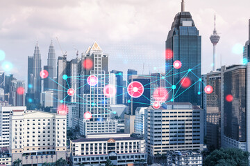 Abstract technology icons hologram over panorama city view of Kuala Lumpur, Malaysia, Asia. The concept of people networking and connections. Double exposure.