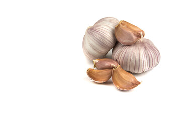fresh garlic in heads and divided into teeth on a white isolated background