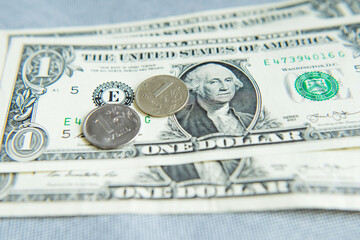 coin one Russian ruble is on the bill 1 dollar.