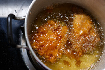 Deep fried pork with hot oil in pot,Fritter