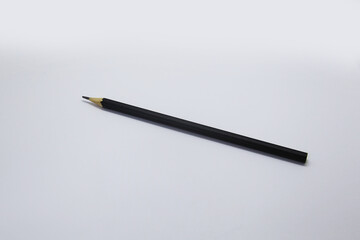 Black pencil, an instrument used to write, draw or doodle is cylindrical and wooden in shape with a graphite on the inside