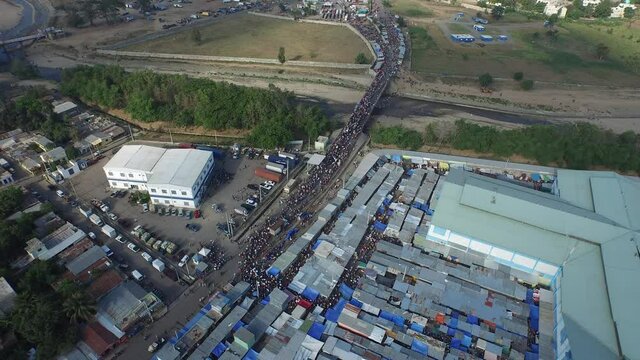 Mass of people cross border at market between Haiti and Dominican Republic. 