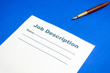 Job description template on the blue office desk with pen