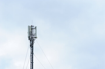 Tower with mobile operator antennas on the background of sky