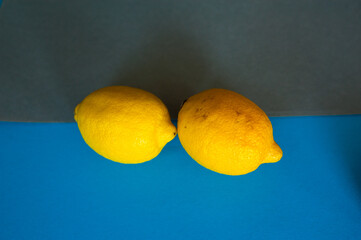 yellow citrus ripe summer fruit. sour sweet lemon. it's on a blue gray background