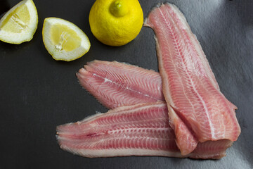 Fresh, unroasted African catfish fillet. Black background
