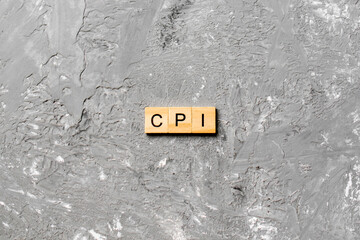 CPI word written on wood block. abbreviation consumer price index text on cement table for your...
