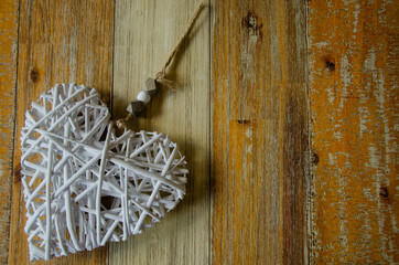 White straw heart ornament on textured background