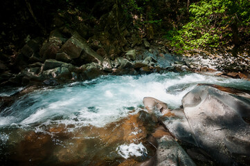 Naklejka na ściany i meble Blue Lagoon, mountain river among the rocks in the forest