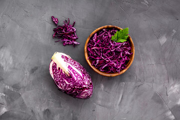 Red cabbage - cut head and sliced - on grey kitchen table top view