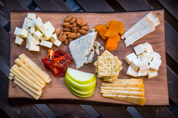 cheese, fruits, and bread on wood