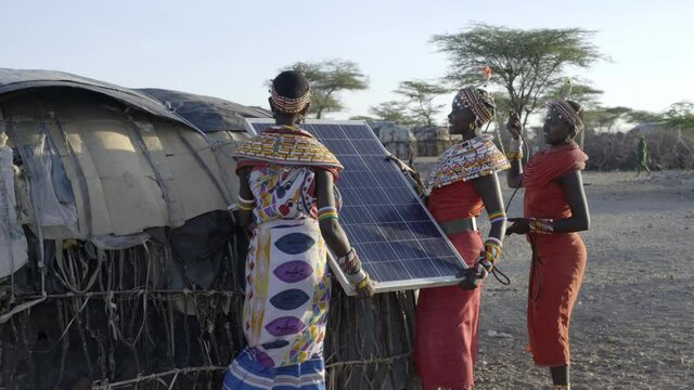Women from the Samburu tribe in Kenya, installing solar panels to generate electricity in their village. 