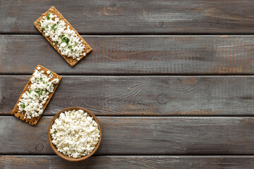 Cottage cheese toast on wooden desk top view copy space