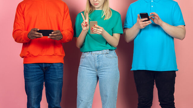 Group Of Friends Using Mobile Smartphones. Teenagers Addiction To New Technology Trends. Close Up. Millenials Scrolling, Reading News, Watching Video Or Shopping Online. Connecting With Devices.