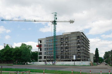 Fototapeta na wymiar A house is being built with a tower crane
