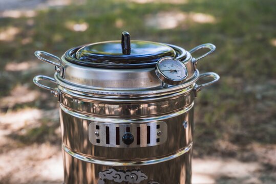Closeup shot of a Spanish kitchen appliance "Putxera" on the ground under sunlight