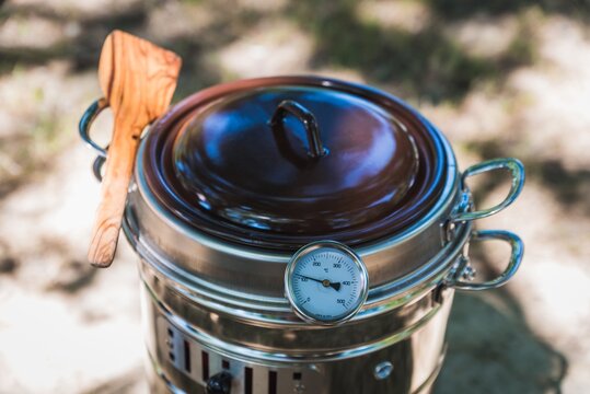 Closeup shot of a Spanish kitchen appliance "Putxera" on the ground under sunlight