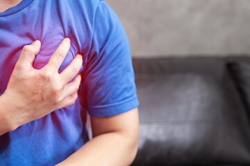 Naklejka premium concept healthcare. man in blue shirt having heart attack.