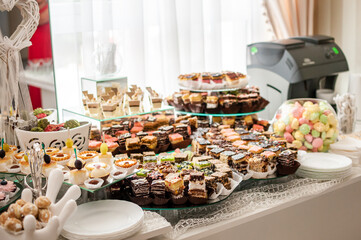 Sweet cakes at a wedding buffet. Catering