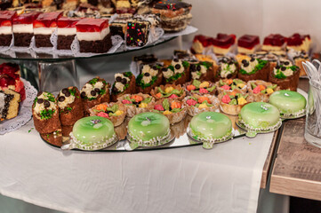 Sweet cakes at a wedding buffet. Catering