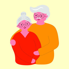 A happy elderly couple, senior citizen health plan, standing embraced together holding their hands. Medical insurance plan.

