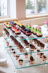 Sweet cakes at a wedding buffet. Catering