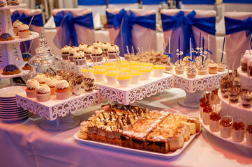 Sweet cakes at a wedding buffet. Catering