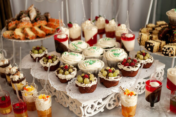 Sweet cakes at a wedding buffet. Catering