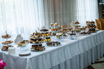 Sweet cakes at a wedding buffet. Catering