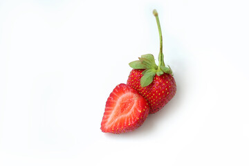 Red fresh strawberry with sliced half and leaves isolated on white background. Copy space. Top view. Strawberries background. Food background. Close-up