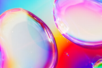 Abstract composition. Drops of liquid are on an iridescent surface. Slightly defocused image....