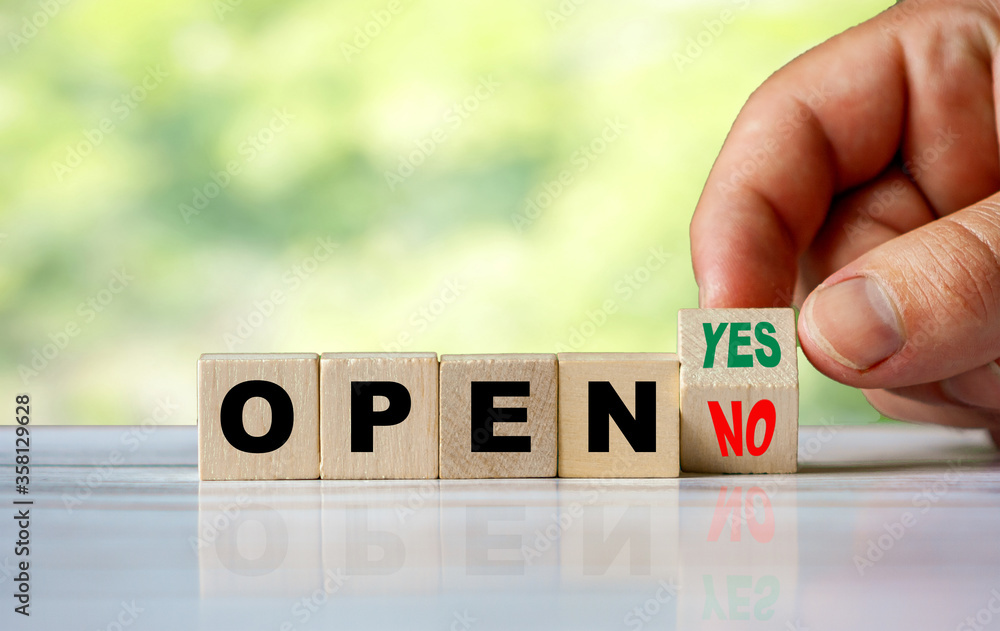 Poster the hand turns the wooden cube and changes the word no open to yes open
