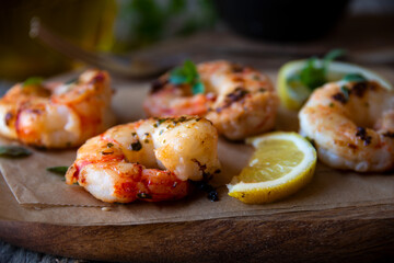 Roasted shrimps with lemon and herbs, healthy seafood meal