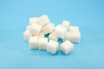 white sugar cubes on a blue background.