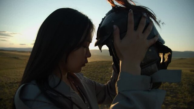 asian girl with mongolian warrior's helmet in sorrow