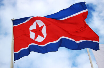 Flag of North Korea against the background of a cloudy sky