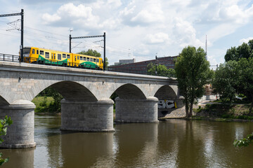 viaduct in the center of Prague on the Vltava river and blue sky with clouds

