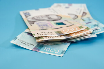 500 and 1000 hryvnia on a blue background. Financial concept. Close-up.