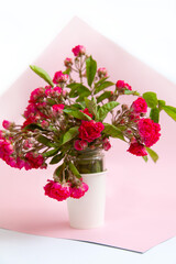 bouquet of small roses in a vase on an empty background